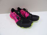 pink and black running shoes with neon accents on a white surface