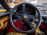 steering wheel and dashboard of a yellow sports car in a garage