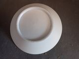 a white plate that has a hole in the middle of it