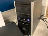 a desktop computer sitting on the floor next to a printer