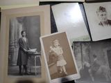many old photos of a woman and a child on a table