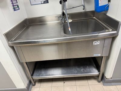 a stainless steel sink with a faucet in the corner