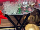 a lot of glasses and bowls on the table