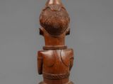 a wooden figure of a man with a hat on his head