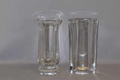 two tall glass vases sitting next to each other on a table