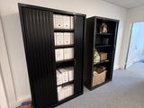 a black cabinet with baskets on it in the corner of a room