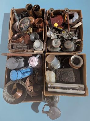 two boxes filled with assorted items sitting on a blue surface