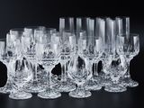 a lot of wine glasses and a pitcher on the table