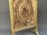 an antique brass fireplace screen with a floral design on it