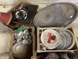 a box full of dirty dishes and bowls sitting on the floor