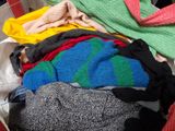 a pile of clothes that is sitting in a basket