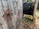 a wooden fence that has a wooden cable spool attached to it