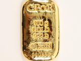 a close up of a gold bar on a white surface