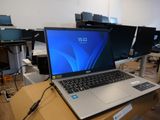 a laptop computer sitting on top of a wooden table