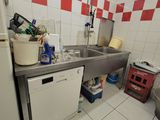 a kitchen with a sink, dishwasher, and refrigerator in it