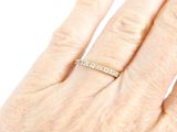 a woman ' s hand with a diamond ring on it