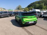 a green car that is parked in a parking lot