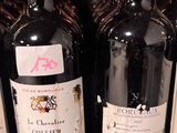 several bottles of wine are lined up on a shelf in a store