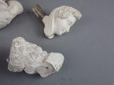 three figurines of a woman and a bird on a table
