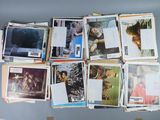 a lot of pictures hanging on the wall of a room