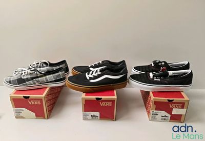 three pairs of vans shoes are sitting on top of boxes