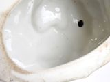 a white porcelain bowl with a hole in it