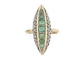 a close up of a gold ring with emeralds and diamonds