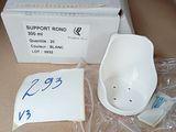 a white bowl sitting on top of a table next to a box