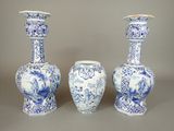 three blue and white vases sitting next to each other