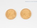 two pieces of gold coins on a white surface