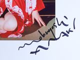 a picture of a woman in a red kimono sitting on the floor