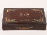 an old wooden box with a decorative design on the lid