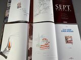 several books with drawings and pictures of people on them sitting on a table