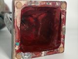 a picture of a ring with a red stone in it