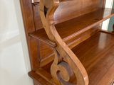 a wooden shelf with a book case on top of it