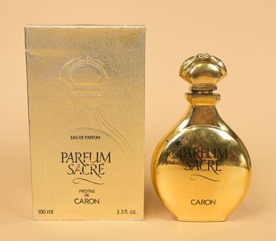 an image of a bottle of perfume sitting next to a box