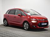 a red citrole is parked in a room with a checkered floor