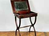 a small wooden table with a chalk board on top of it