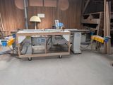 a picture of a workbench with a table and a lamp in it