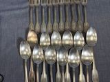 a lot of silver spoons and spoon spoons on a table