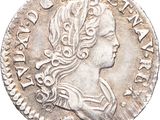 une pièce en argent avec l'image d'une femme de profil