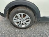 a close up of a car ' s tire on the road