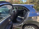 a car that is parked in the grass with its door open