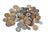 a pile of coins sitting on top of a white surface