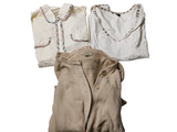three pieces of clothing sitting on a white surface