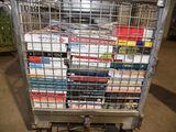 a metal cart with many books on it in a store