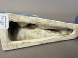 porcelain figurine of a man with a pipe in his mouth