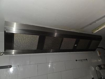 a picture of a stainless steel range hood in a kitchen