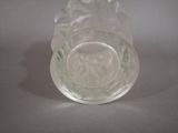a clear glass vase with a flower inside of it