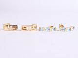 three pairs of gold and blue stone stud earrings